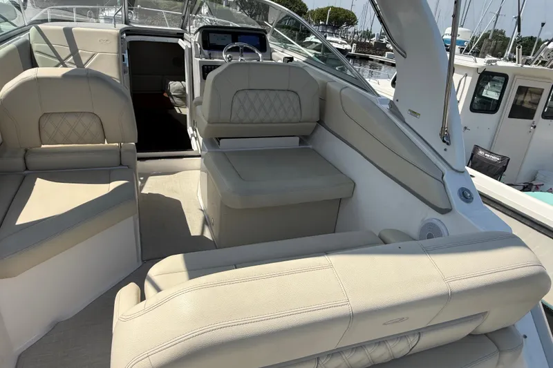 Slide: The Image of 2023 Regal 26 XO boat interior with beige seating and modern dashboard. - 6