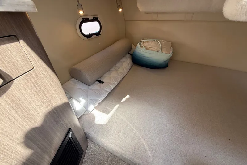 Slide: The Image of Cozy interior cabin of 2023 Regal 26 XO boat with soft lighting and bedding. - 33
