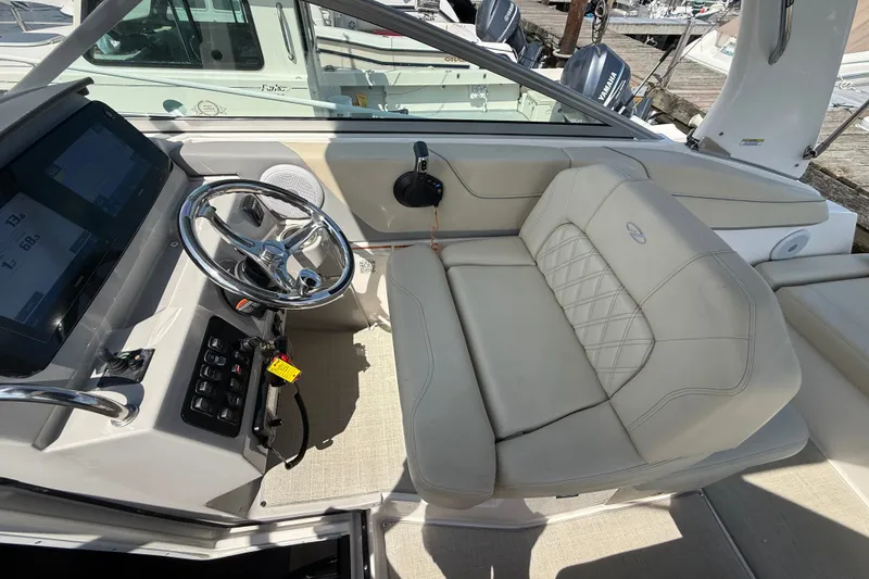 Slide: The Image of 2023 Regal 26 XO boat interior with steering wheel and plush seating. - 20
