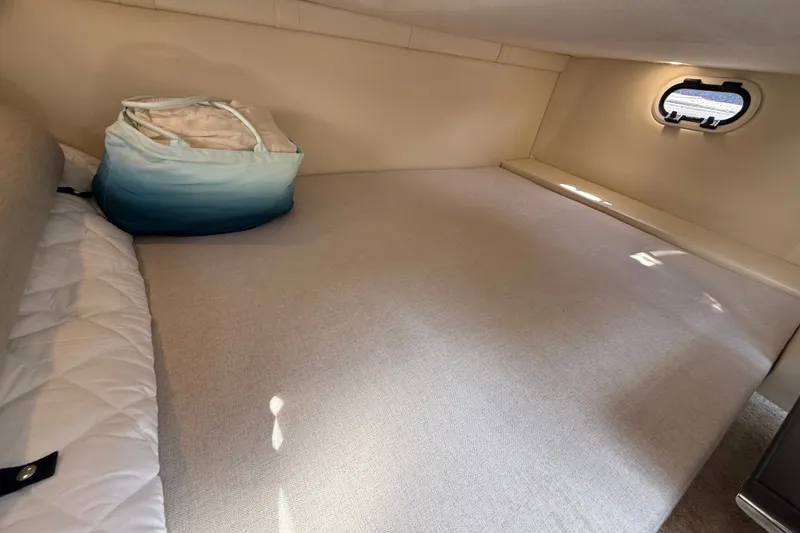 Slide: The Image of 2023 Regal 26 XO cabin interior with cozy bed and small window. - 34