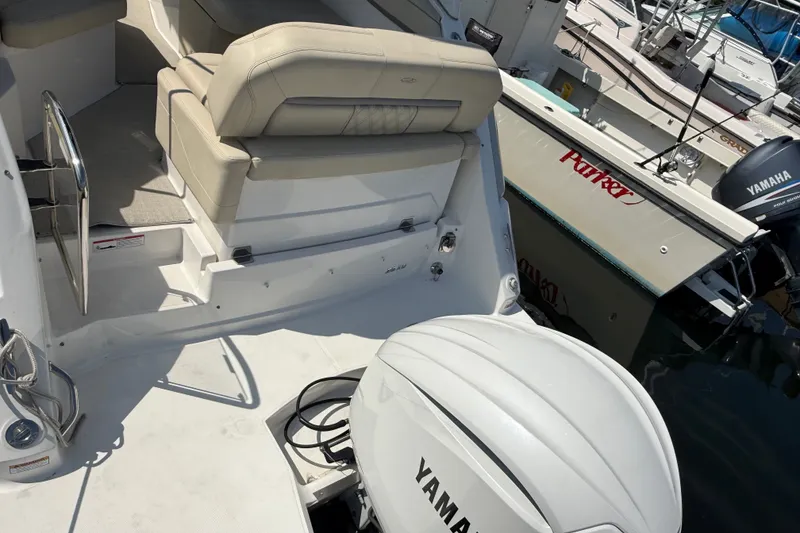 Slide: The Image of 2023 Regal 26 XO boat with Yamaha outboard engine, featuring beige seating and docked at a marina. - 5