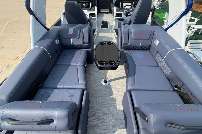 Slide: The Image of Luxurious interior of 2027 Sylvan G5 LZ DC boat with plush seating and central table. - 24