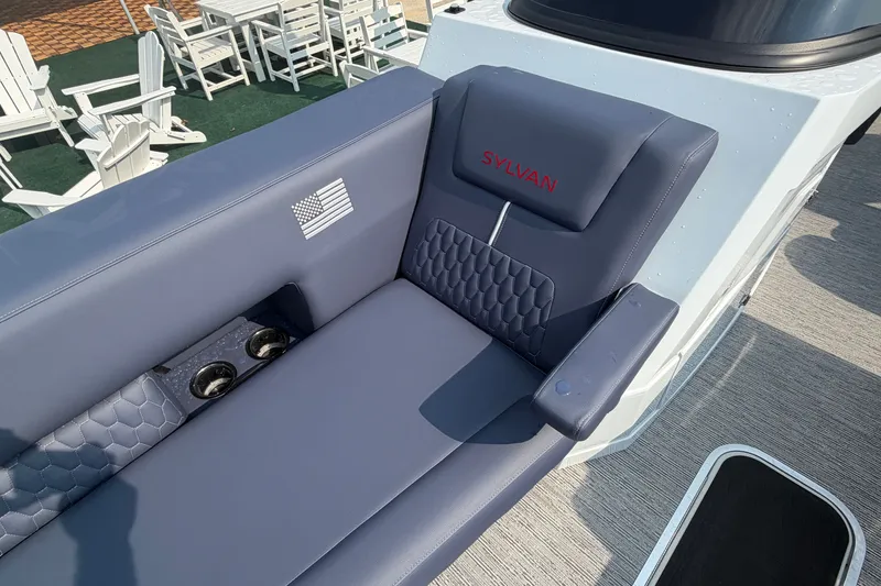 Slide: The Image of Luxurious seating on 2027 Sylvan G5 LZ DC boat with cup holders and American flag detail. - 9