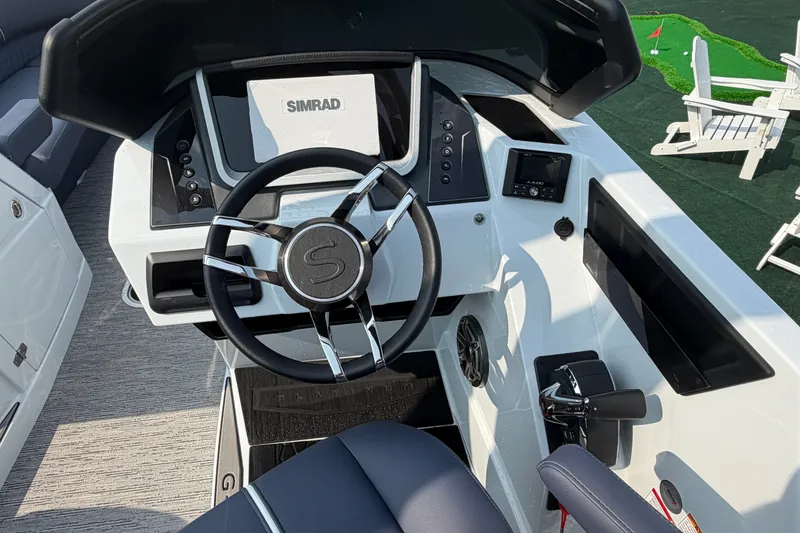 Slide: The Image of 2027 Sylvan G5 LZ DC boat dashboard with steering wheel and Simrad display. - 17