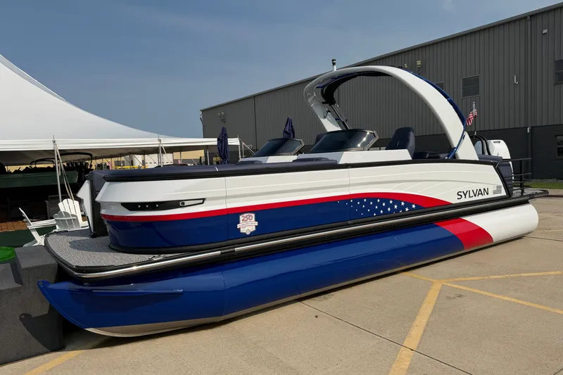 The Image of 2027 Sylvan G5 LZ DC pontoon boat with patriotic design, displayed outdoors. - 1