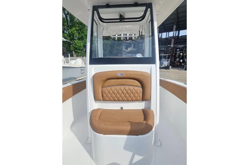 Slide: The Image of 2027 Sea Hunt Ultra 239 SE boat interior with tan cushioned seating. - 25