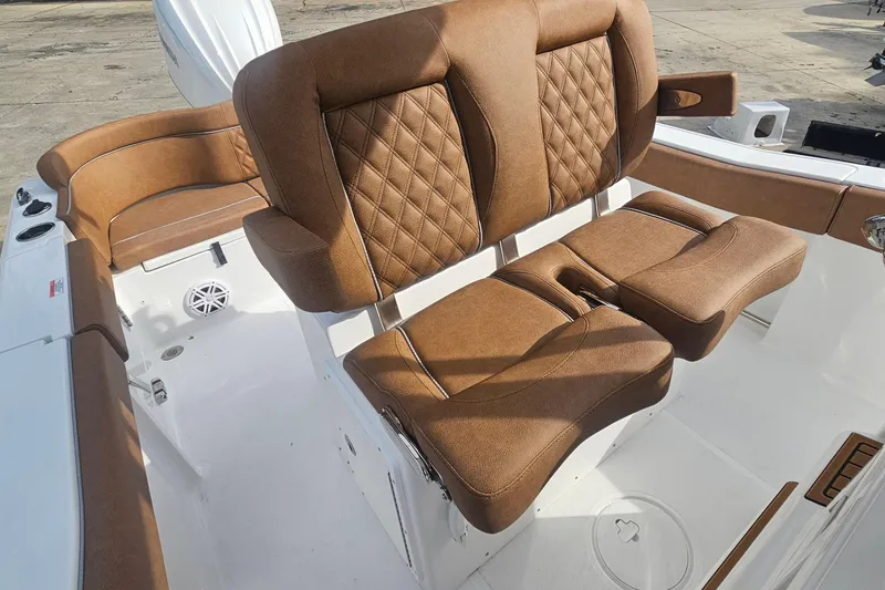 Slide: The Image of Luxurious brown seating on 2027 Sea Hunt Ultra 239 SE boat, featuring diamond stitching. - 17