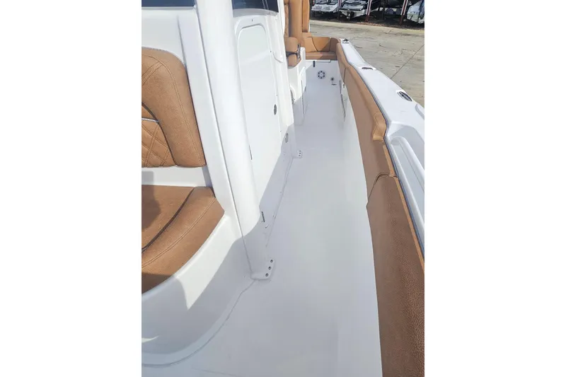 Slide: The Image of 2027 Sea Hunt Ultra 239 SE boat interior with brown seating and white deck. - 28
