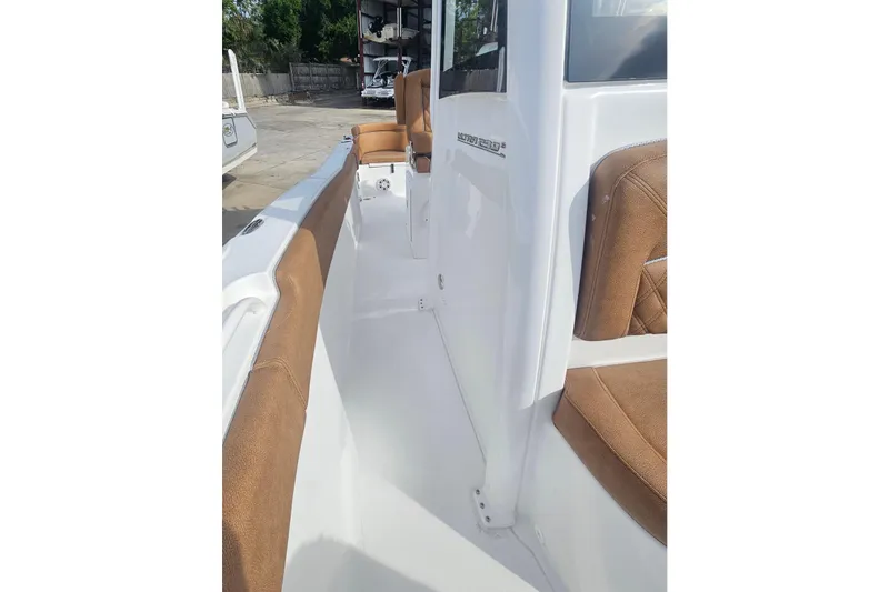 Slide: The Image of 2027 Sea Hunt Ultra 239 SE boat interior with brown seating and white deck. - 29