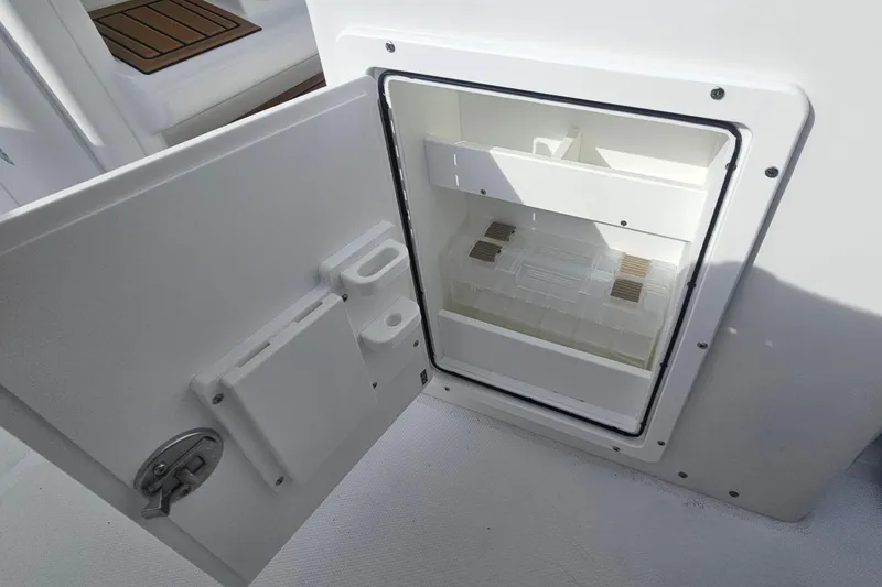 Slide: The Image of Open storage compartment on 2027 Sea Hunt Ultra 239 SE boat, showcasing interior space. - 19