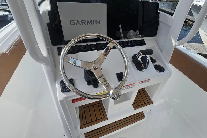 Slide: The Image of Steering console of 2027 Sea Hunt Ultra 239 SE with Garmin navigation system. - 18