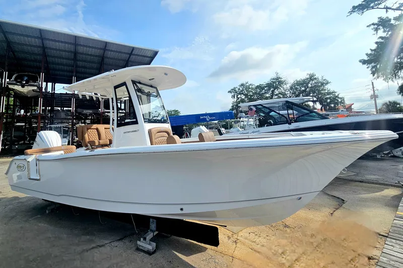 Slide: The Image of 2027 Sea Hunt Ultra 239 SE boat displayed outdoors under a clear sky. - 9