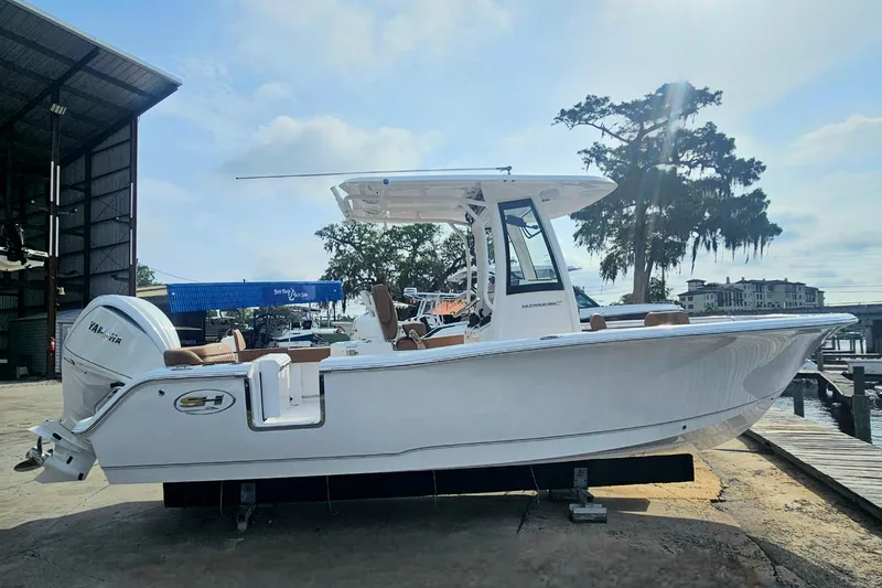 Slide: The Image of 2027 Sea Hunt Ultra 239 SE boat docked, side view with Yamaha engine. - 8