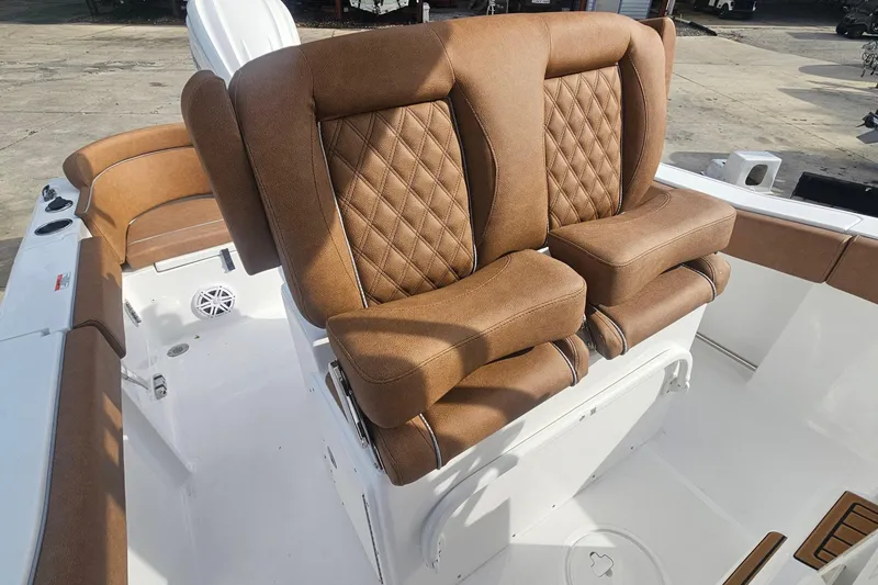 Slide: The Image of Luxurious seating on 2027 Sea Hunt Ultra 239 SE boat, featuring brown leather upholstery. - 16