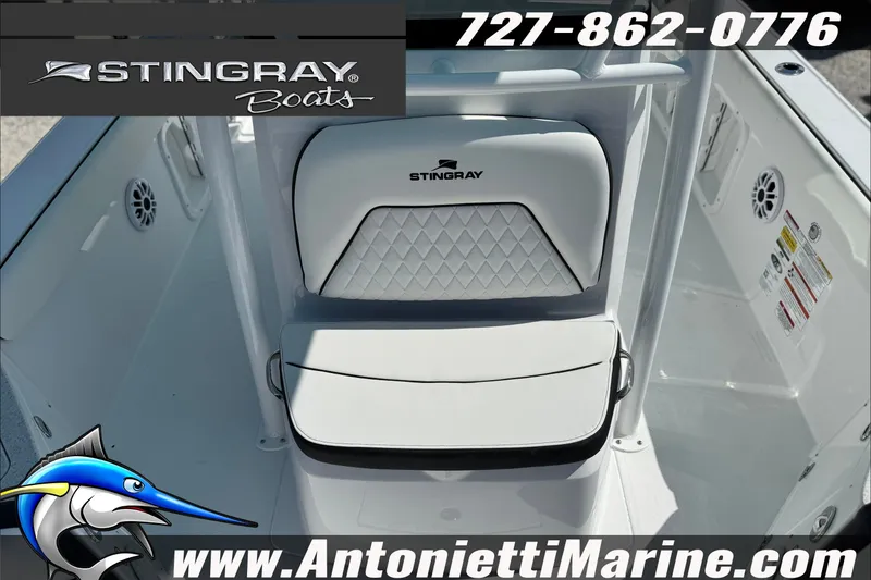 Slide: The Image of Stingray 24 HY boat interior with logo, featuring white seating and marine details. - 11