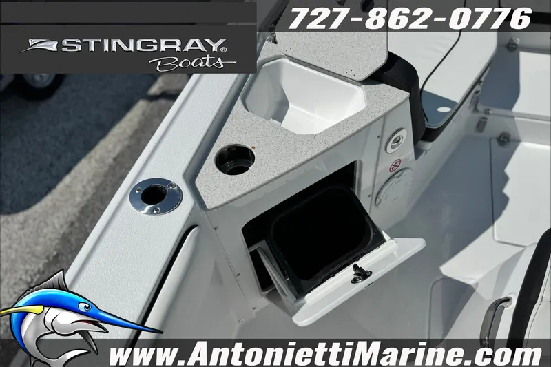 Slide: The Image of 2027 Stingray 24 HY boat interior with storage compartment and cup holder. - 10
