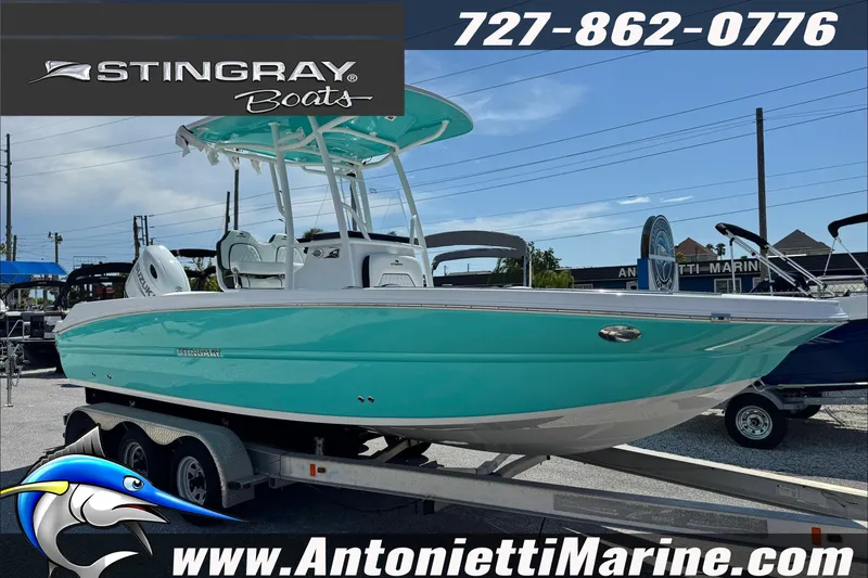 The Image of 2027 Stingray 24 HY boat in turquoise on trailer at Antonietti Marine dealership. - 0