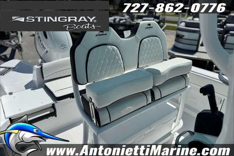 Slide: The Image of 2027 Stingray 24 HY boat interior with white seating, logo, and contact details. - 12