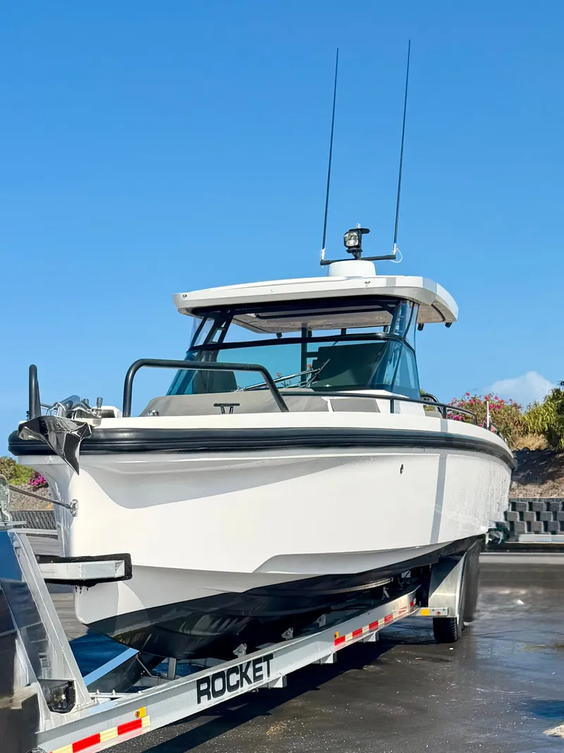 Slide: The Image of A 2021 Axopar 37 Sun-Top boat on a trailer, ready for transport. - 0