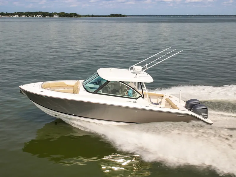 Slide: The Image of A 2015 Pursuit DC 325 Dual Console boat speeding across calm water. - 3