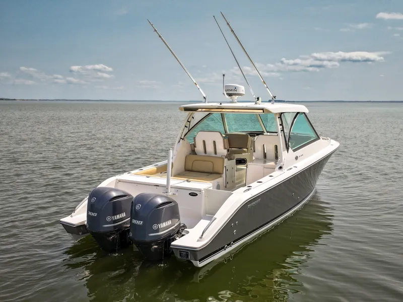 Slide: The Image of A 2015 Pursuit DC 325 Dual Console boat on calm water with two Yamaha engines. - 10