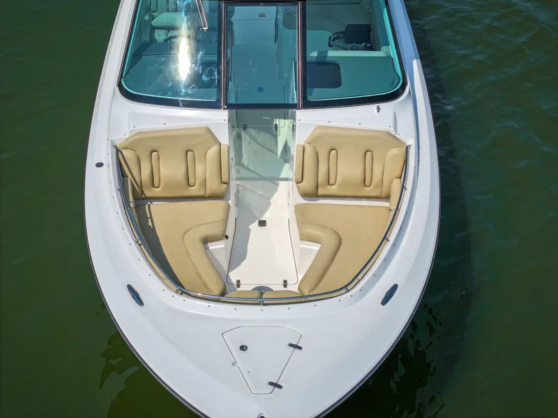 Slide: The Image of The 2015 Pursuit DC 325 Dual Console features an open bow section with beige seating. - 25