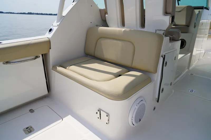 Slide: The Image of The beige seating on the boat offers comfortable padding and is positioned next to a speaker. - 46