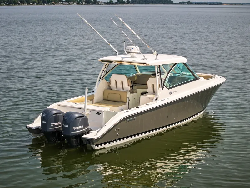 Slide: The Image of A 2015 Pursuit DC 325 Dual Console boat on calm water with two outboard engines. - 30