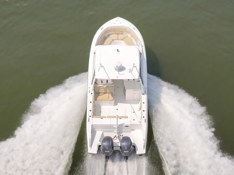 Slide: The Image of A white boat with two outboard engines speeds across the water. - 5