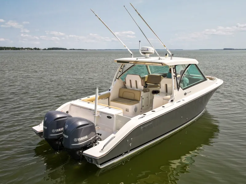 Slide: The Image of A 2015 Pursuit DC 325 Dual Console boat on calm water with twin Yamaha engines. - 11