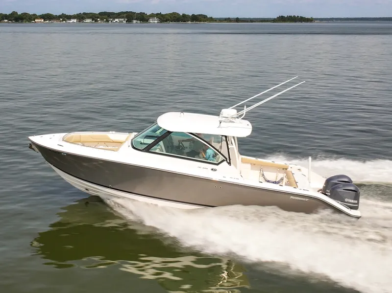Slide: The Image of A 2015 Pursuit DC 325 Dual Console speeding across calm waters. - 4