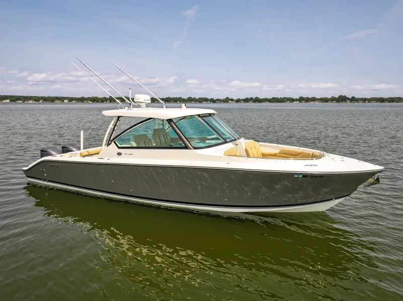 Slide: The Image of A 2015 Pursuit DC 325 Dual Console boat on calm water. - 29