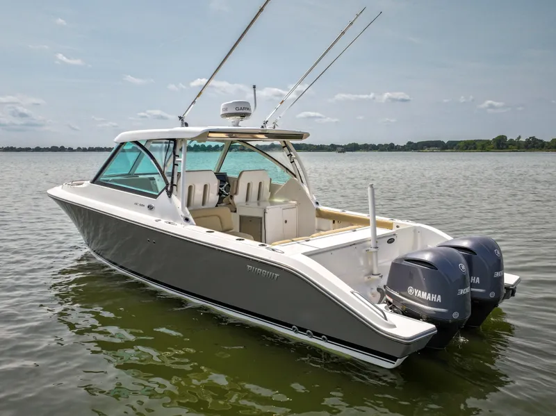 Slide: The Image of A 2015 Pursuit DC 325 Dual Console boat on calm water with twin Yamaha engines. - 14
