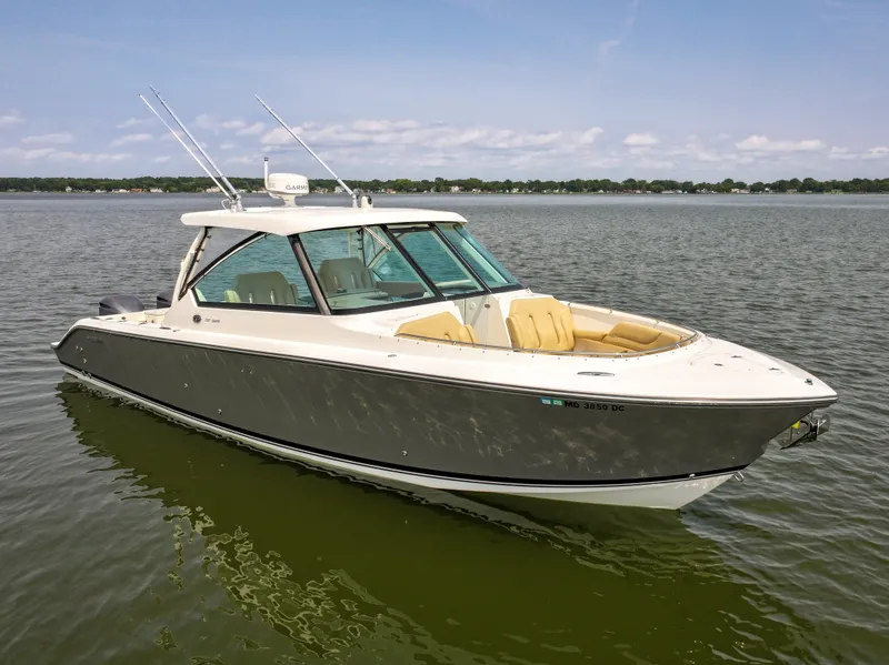 Slide: The Image of A 2015 Pursuit DC 325 Dual Console boat floating on calm water. - 28