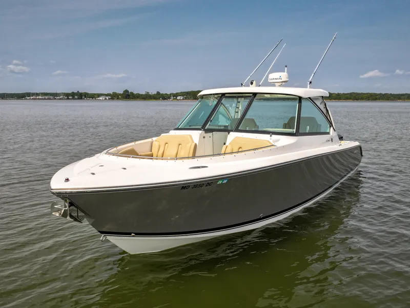 Slide: The Image of A 2015 Pursuit DC 325 Dual Console boat on calm water. - 20