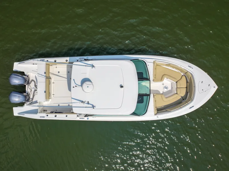 Slide: The Image of Aerial view of a Pursuit DC 325 Dual Console boat on calm water. - 6
