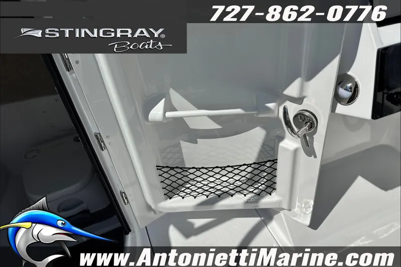 Slide: The Image of 2027 Stingray 24 DC boat interior with storage compartment and key lock. - 18