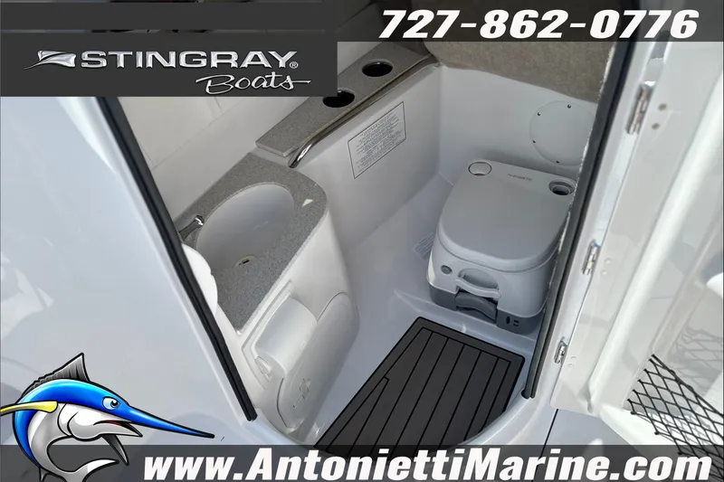 Slide: The Image of Interior of 2027 Stingray 24 DC boat featuring compact marine toilet and sink. - 14