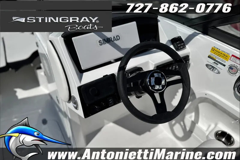 Slide: The Image of 2027 Stingray 24 DC boat dashboard with steering wheel and Simrad display. - 19