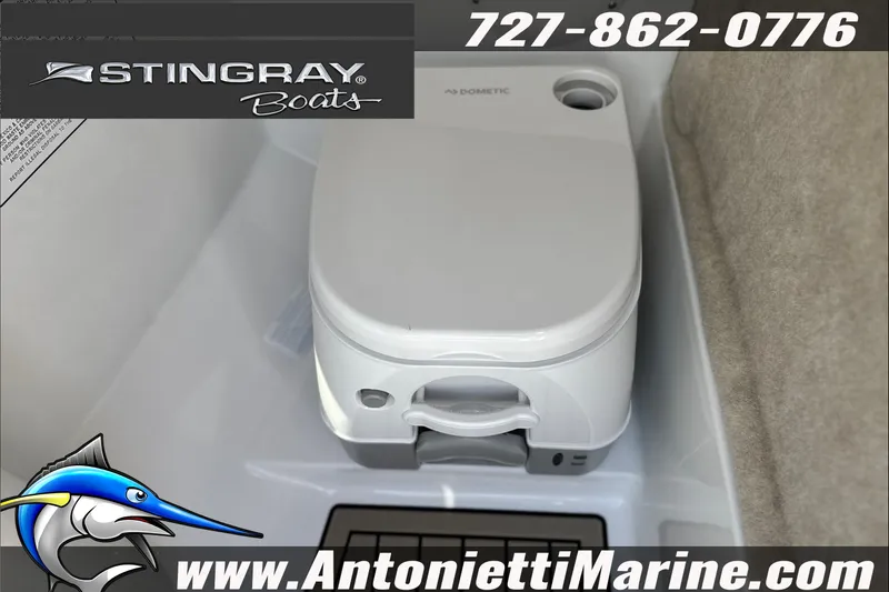 Slide: The Image of 2027 Stingray 24 DC boat interior featuring a compact Dometic toilet. - 16
