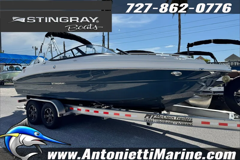 The Image of 2027 Stingray 24 DC boat on trailer at Antonietti Marine dealership. - 0