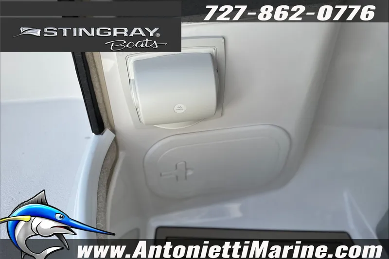 Slide: The Image of 2027 Stingray 24 DC boat interior detail with logo and contact information. - 17