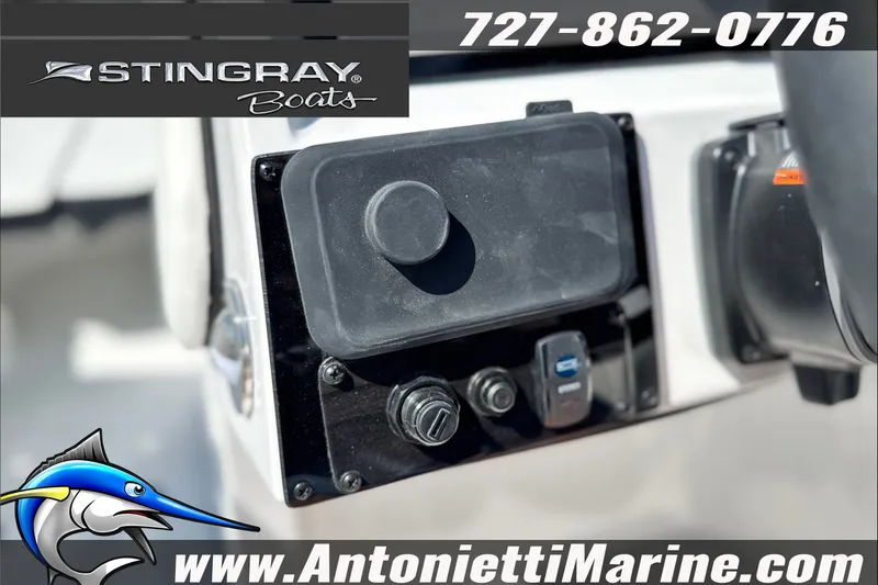 Slide: The Image of Control panel of 2027 Stingray 24 DC boat, featuring marine electronics and branding. - 21