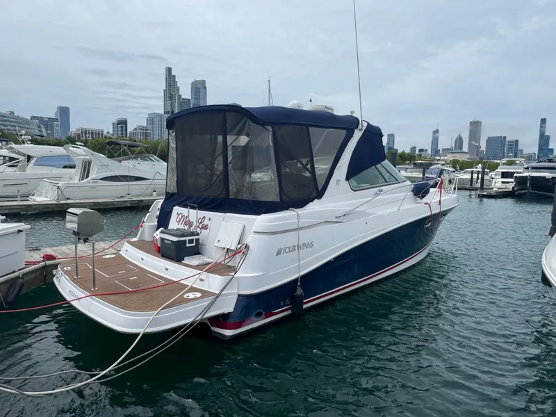 Slide: The Image of 2007 Four Winns 378 Vista yacht docked in marina with city skyline in background. - 2