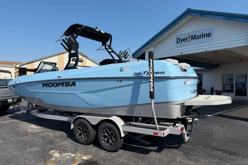 Slide: The Image of 2025 Moomba Tykon boat in light blue on trailer at Dyer Marine dealership. - 2