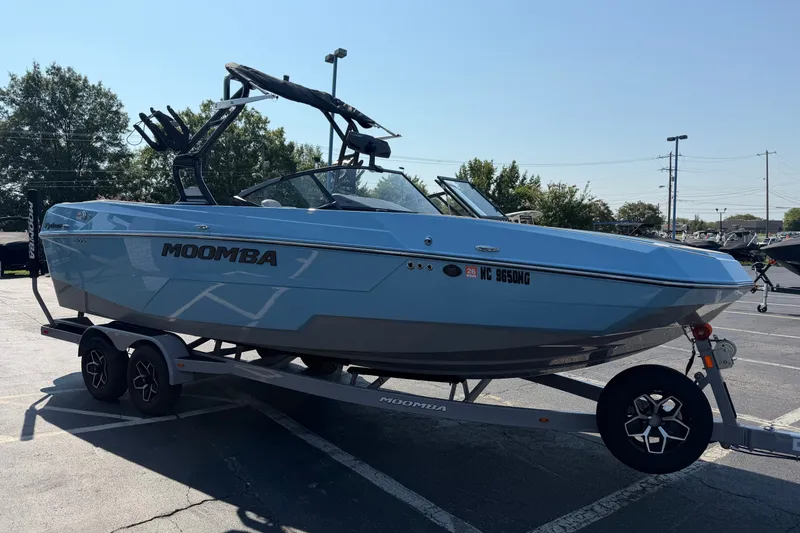 Slide: The Image of 2025 Moomba Tykon boat on trailer in parking lot, side view. - 5