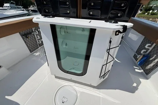 Slide: The Image of 2021 Wellcraft 242 Fisherman boat interior with storage compartments and fishing rod holders. - 20