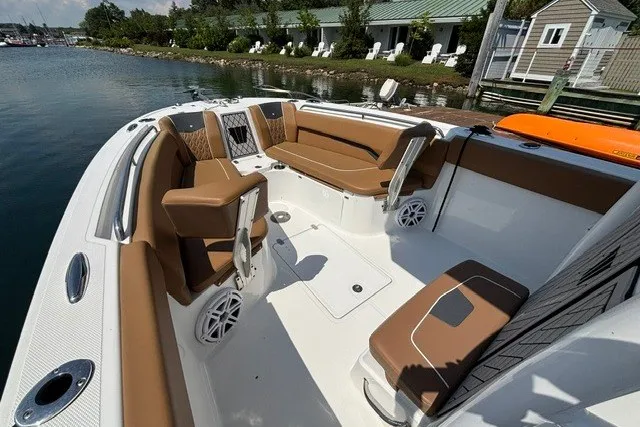 Slide: The Image of 2021 Wellcraft 242 Fisherman boat interior with brown seating and waterfront view. - 8