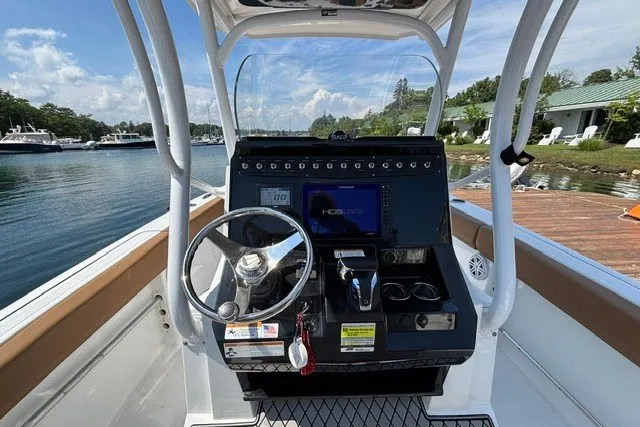 Slide: The Image of 2021 Wellcraft 242 Fisherman boat dashboard with steering wheel and navigation system. - 11