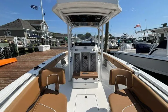 Slide: The Image of 2021 Wellcraft 242 Fisherman boat docked, featuring spacious seating and modern design. - 7